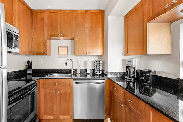 1830 Embassy Dr Unit 401, West Palm Beach, FL 33401 - kitchen featuring stainless steel appliances, dark stone countertops, and brown cabinetry