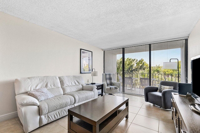 1830 Embassy Dr Unit 401, West Palm Beach, FL 33401 - living room with a textured ceiling, a wall of windows, and light tile patterned flooring