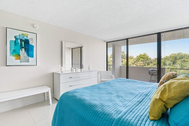 1830 Embassy Dr Unit 401, West Palm Beach, FL 33401 - tiled bedroom featuring a textured ceiling