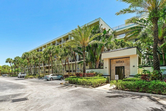 1830 Embassy Dr Unit 401, West Palm Beach, FL 33401 - view of building exterior with uncovered parking
