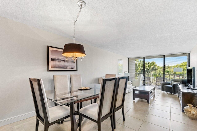 1830 Embassy Dr Unit 401, West Palm Beach, FL 33401 - dining area with a textured ceiling, a chandelier, floor to ceiling windows, and light tile patterned floors