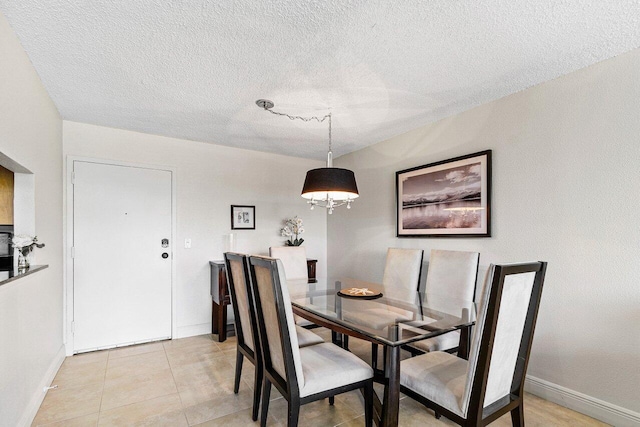 1830 Embassy Dr Unit 401, West Palm Beach, FL 33401 - dining room with a textured ceiling and light tile patterned floors