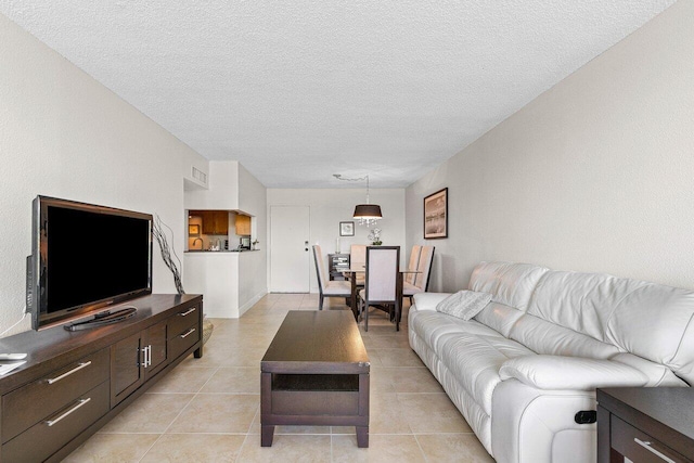 1830 Embassy Dr Unit 401, West Palm Beach, FL 33401 - living room featuring a textured ceiling and light tile patterned floors