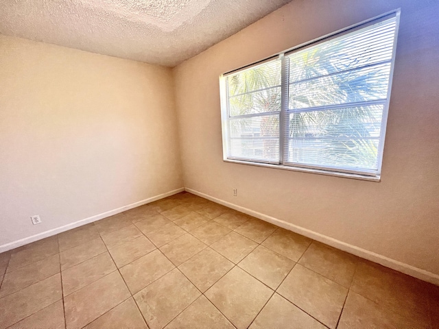 120 Sparrow Dr Unit 302, Royal Palm Beach, FL 33411 - unfurnished room featuring a textured ceiling and light tile patterned floors