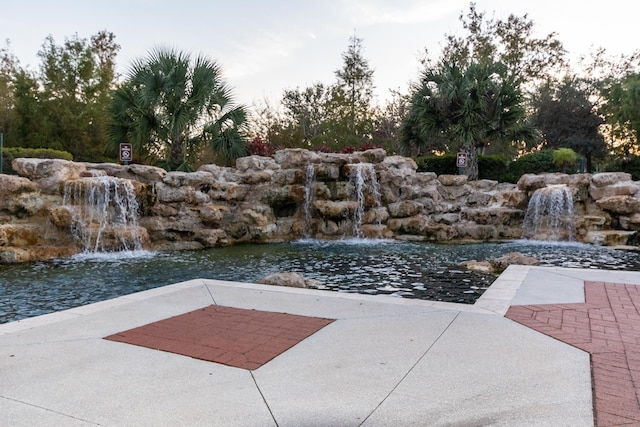 120 Sparrow Dr Unit 302, Royal Palm Beach, FL 33411 - view of patio / terrace with a garden pond