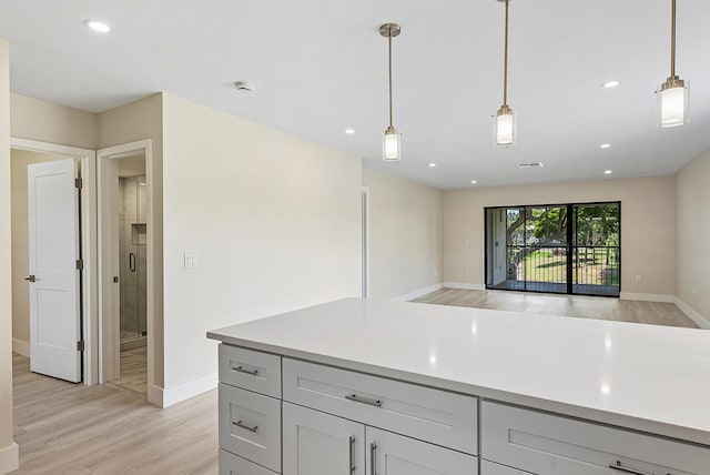 23 Stratford Dr Unit H, Boynton Beach, FL 33436 - kitchen featuring light wood-style flooring, light countertops, decorative light fixtures, recessed lighting, and open floor plan