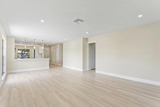 23 Stratford Dr Unit H, Boynton Beach, FL 33436 - unfurnished living room with light wood-style floors and recessed lighting