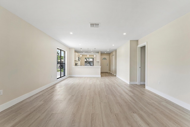 23 Stratford Dr Unit H, Boynton Beach, FL 33436 - unfurnished living room featuring light wood finished floors and recessed lighting