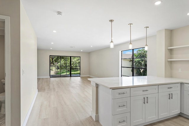 23 Stratford Dr Unit H, Boynton Beach, FL 33436 - kitchen featuring open shelves, a peninsula, light wood-type flooring, light countertops, and recessed lighting