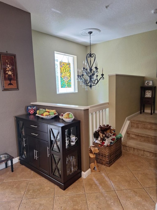 3172 N Greenleaf Cir, Boynton Beach, FL 33426 - foyer featuring a chandelier, light tile patterned flooring, and a textured ceiling