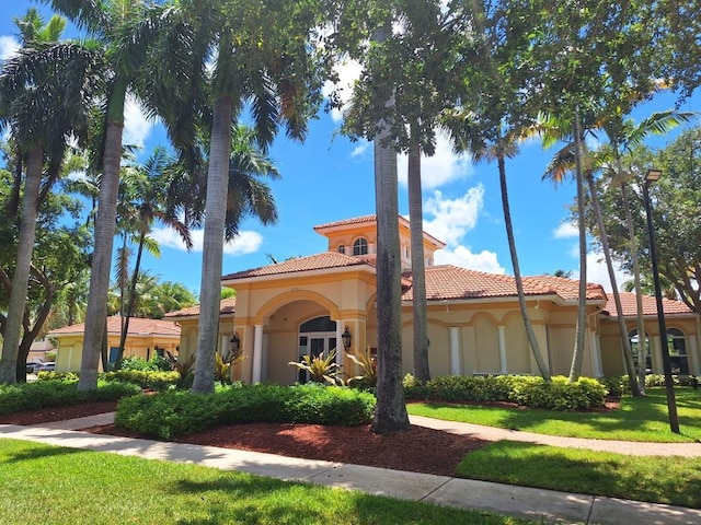 3172 N Greenleaf Cir, Boynton Beach, FL 33426 - view of front of house with a tiled roof, stucco siding, and a front yard