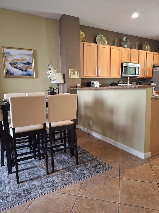 3172 N Greenleaf Cir, Boynton Beach, FL 33426 - kitchen featuring stainless steel microwave, light brown cabinets, tile patterned flooring, and recessed lighting