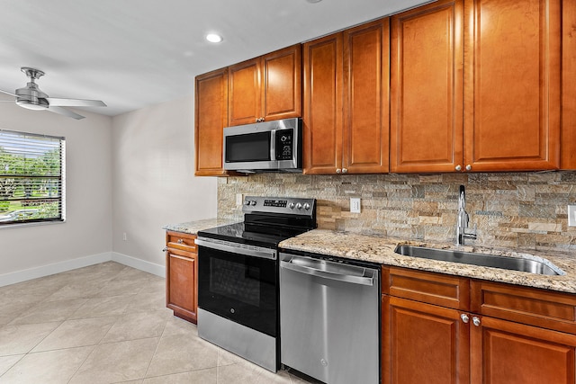 24 Stratford Dr Unit F, Boynton Beach, FL 33436 - kitchen featuring appliances with stainless steel finishes, ceiling fan, backsplash, light stone countertops, and recessed lighting