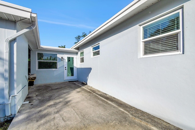 1446 W Perry St, Lantana, FL 33462 - view of property exterior with a patio area and stucco siding