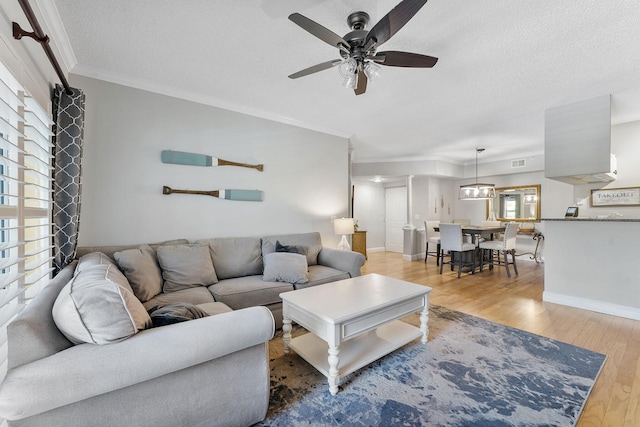 2218 Tuscany Way, Boynton Beach, FL 33435 - living room featuring wood finished floors, plenty of natural light, a ceiling fan, ornamental molding, and a textured ceiling