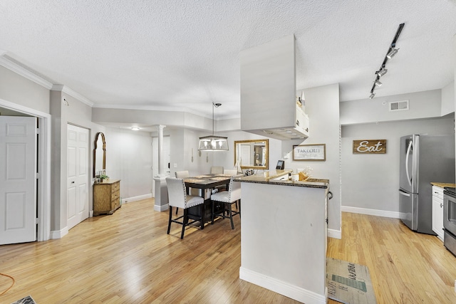 2218 Tuscany Way, Boynton Beach, FL 33435 - kitchen featuring light wood-type flooring, a textured ceiling, dark stone countertops, track lighting, and freestanding refrigerator