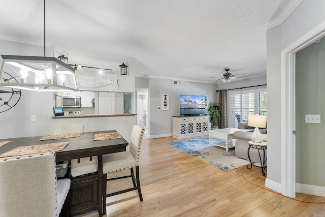 2218 Tuscany Way, Boynton Beach, FL 33435 - dining area featuring ceiling fan, crown molding, light wood-type flooring, and a textured ceiling