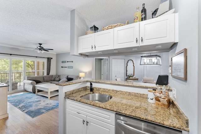 2218 Tuscany Way, Boynton Beach, FL 33435 - kitchen with stainless steel dishwasher, open floor plan, a textured ceiling, light wood-type flooring, and a ceiling fan