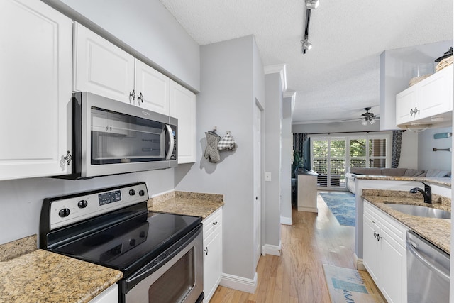 2218 Tuscany Way, Boynton Beach, FL 33435 - kitchen featuring stainless steel appliances, a textured ceiling, light wood-style flooring, a ceiling fan, and white cabinetry