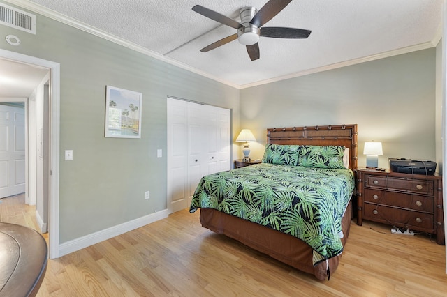 2218 Tuscany Way, Boynton Beach, FL 33435 - bedroom with wood finished floors, crown molding, a closet, a textured ceiling, and a ceiling fan