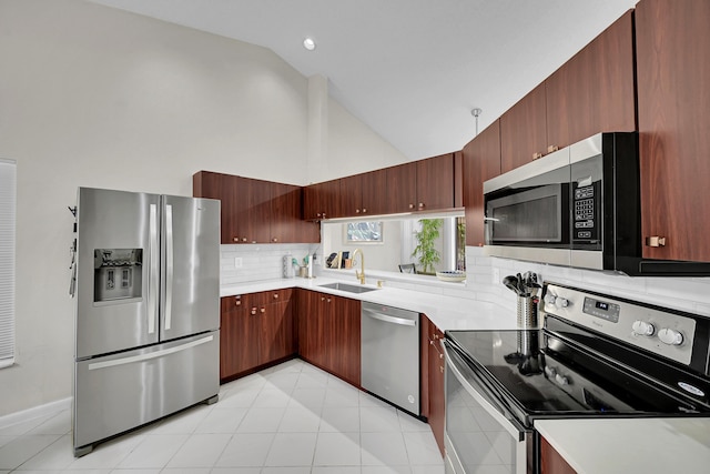 7861 Lexington Club Blvd Unit A, Delray Beach, FL 33446 - kitchen with stainless steel appliances, backsplash, light countertops, high vaulted ceiling, and light tile patterned flooring