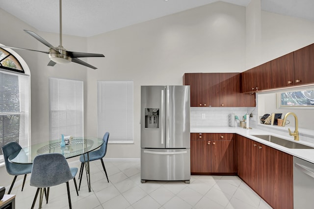 7861 Lexington Club Blvd Unit A, Delray Beach, FL 33446 - kitchen featuring stainless steel appliances, light countertops, ceiling fan, high vaulted ceiling, and backsplash