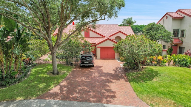7861 Lexington Club Blvd Unit A, Delray Beach, FL 33446 - view of front of house with decorative driveway, stucco siding, a front yard, and an attached garage