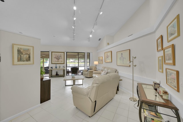 7861 Lexington Club Blvd Unit A, Delray Beach, FL 33446 - living area with light tile patterned flooring, vaulted ceiling, and track lighting