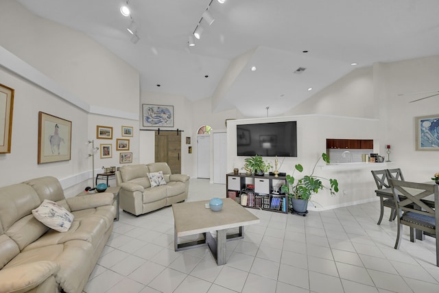 7861 Lexington Club Blvd Unit A, Delray Beach, FL 33446 - living area featuring high vaulted ceiling, rail lighting, and a barn door