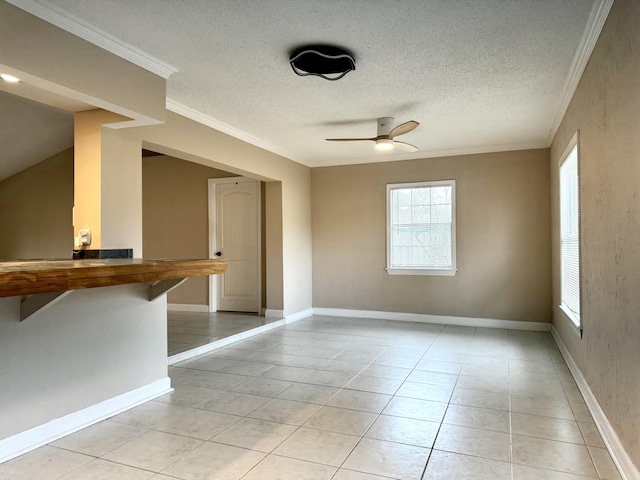 610 SE Forgal St, Port Saint Lucie, FL 34983 - unfurnished room with ceiling fan, crown molding, a textured ceiling, and light tile patterned floors