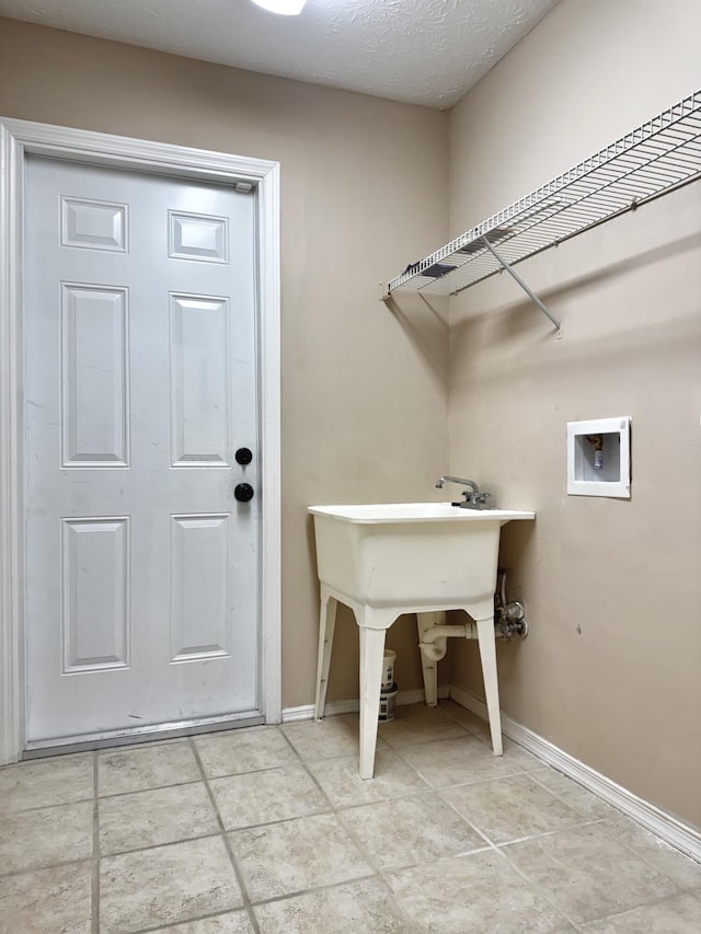 610 SE Forgal St, Port Saint Lucie, FL 34983 - laundry room featuring washer hookup and light tile patterned floors