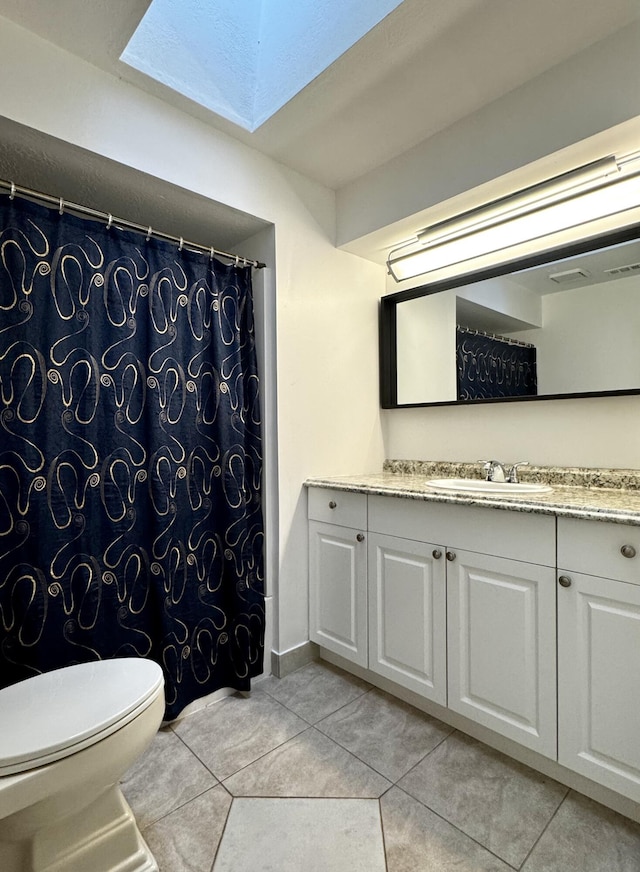 610 SE Forgal St, Port Saint Lucie, FL 34983 - full bathroom featuring vanity, a skylight, tile patterned flooring, and a shower with curtain