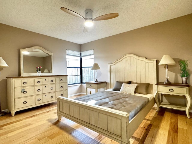 610 SE Forgal St, Port Saint Lucie, FL 34983 - bedroom featuring a textured ceiling, light wood finished floors, and ceiling fan