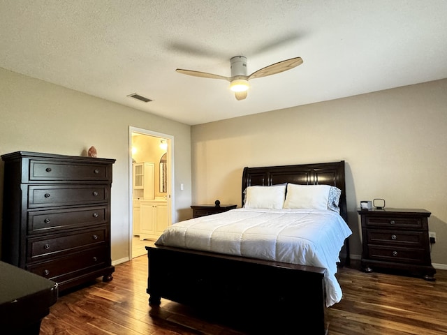 610 SE Forgal St, Port Saint Lucie, FL 34983 - bedroom featuring dark wood-type flooring, ensuite bathroom, and a ceiling fan