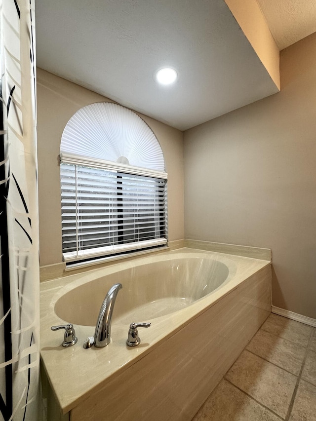 610 SE Forgal St, Port Saint Lucie, FL 34983 - bathroom featuring a bath, tile patterned floors, and recessed lighting