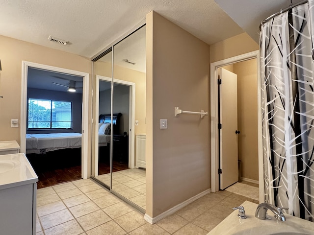 610 SE Forgal St, Port Saint Lucie, FL 34983 - full bathroom with ensuite bathroom, vanity, tile patterned floors, and a textured ceiling
