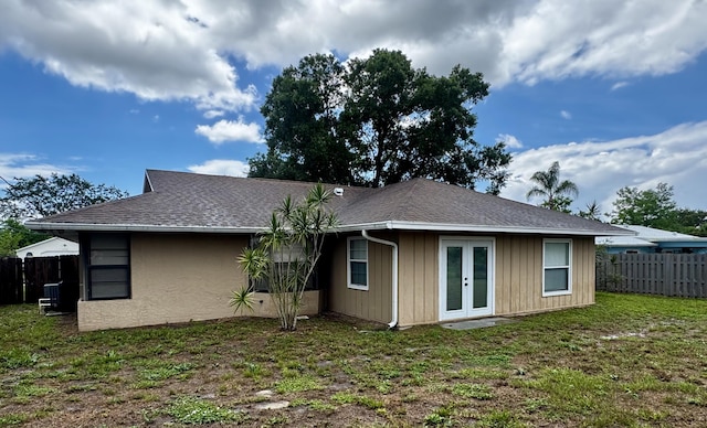 610 SE Forgal St, Port Saint Lucie, FL 34983 - rear view of house featuring french doors and roof with shingles