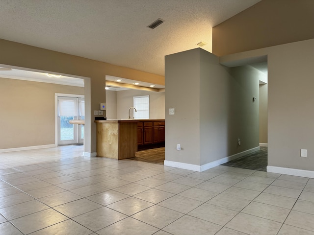 610 SE Forgal St, Port Saint Lucie, FL 34983 - unfurnished living room featuring light tile patterned flooring, a textured ceiling, and healthy amount of natural light