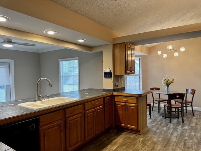610 SE Forgal St, Port Saint Lucie, FL 34983 - kitchen featuring black dishwasher, a peninsula, brown cabinetry, a textured ceiling, and recessed lighting