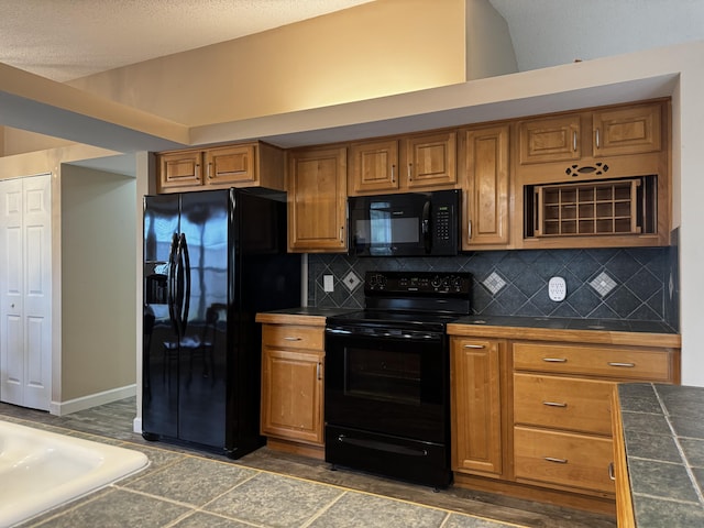 610 SE Forgal St, Port Saint Lucie, FL 34983 - kitchen with black appliances, brown cabinetry, and tasteful backsplash