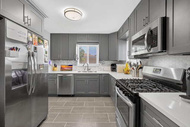 306 N A St, Lake Worth Beach, FL 33460 - kitchen featuring stainless steel appliances, gray cabinetry, backsplash, and light countertops