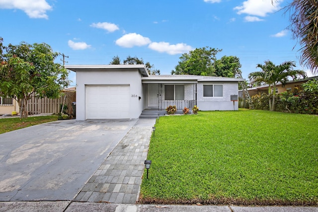 306 N A St, Lake Worth Beach, FL 33460 - view of front of property with an attached garage, stucco siding, driveway, and a porch