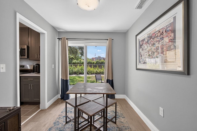 306 N A St, Lake Worth Beach, FL 33460 - dining area with light wood finished floors and baseboards