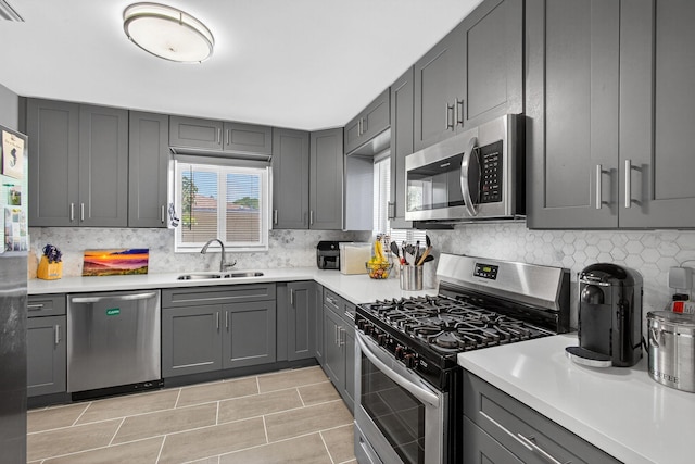 306 N A St, Lake Worth Beach, FL 33460 - kitchen with stainless steel appliances, gray cabinetry, light countertops, and backsplash