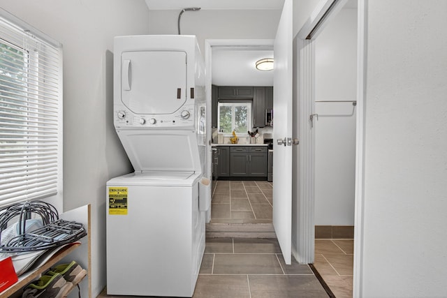 306 N A St, Lake Worth Beach, FL 33460 - laundry area featuring stacked washer / dryer and tile patterned flooring