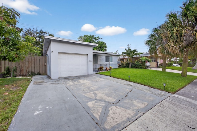 306 N A St, Lake Worth Beach, FL 33460 - mid-century home with a garage, stucco siding, and concrete driveway