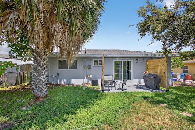 306 N A St, Lake Worth Beach, FL 33460 - back of property featuring stucco siding and a patio