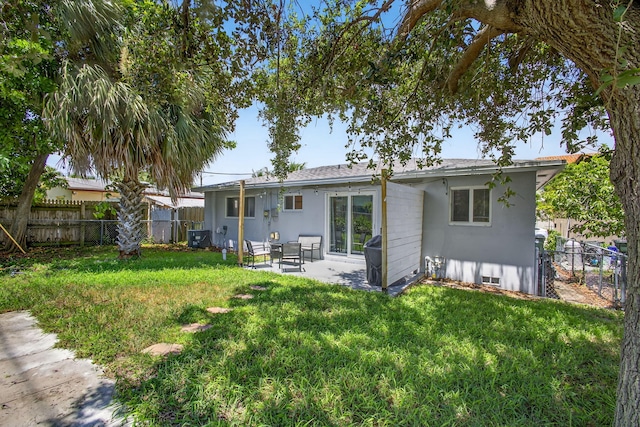306 N A St, Lake Worth Beach, FL 33460 - rear view of property with a fenced backyard and a patio area