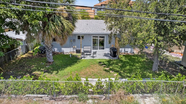 306 N A St, Lake Worth Beach, FL 33460 - rear view of property with a patio, a fenced backyard, and roof with shingles
