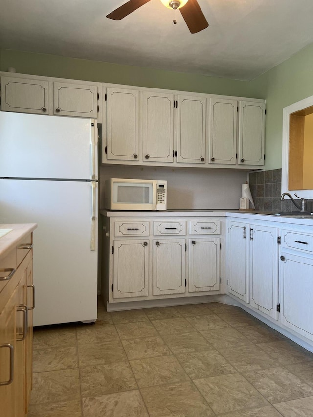 2112 NE 1st Way Unit 206, Boynton Beach, FL 33435 - kitchen featuring white appliances, ceiling fan, tasteful backsplash, and white cabinetry